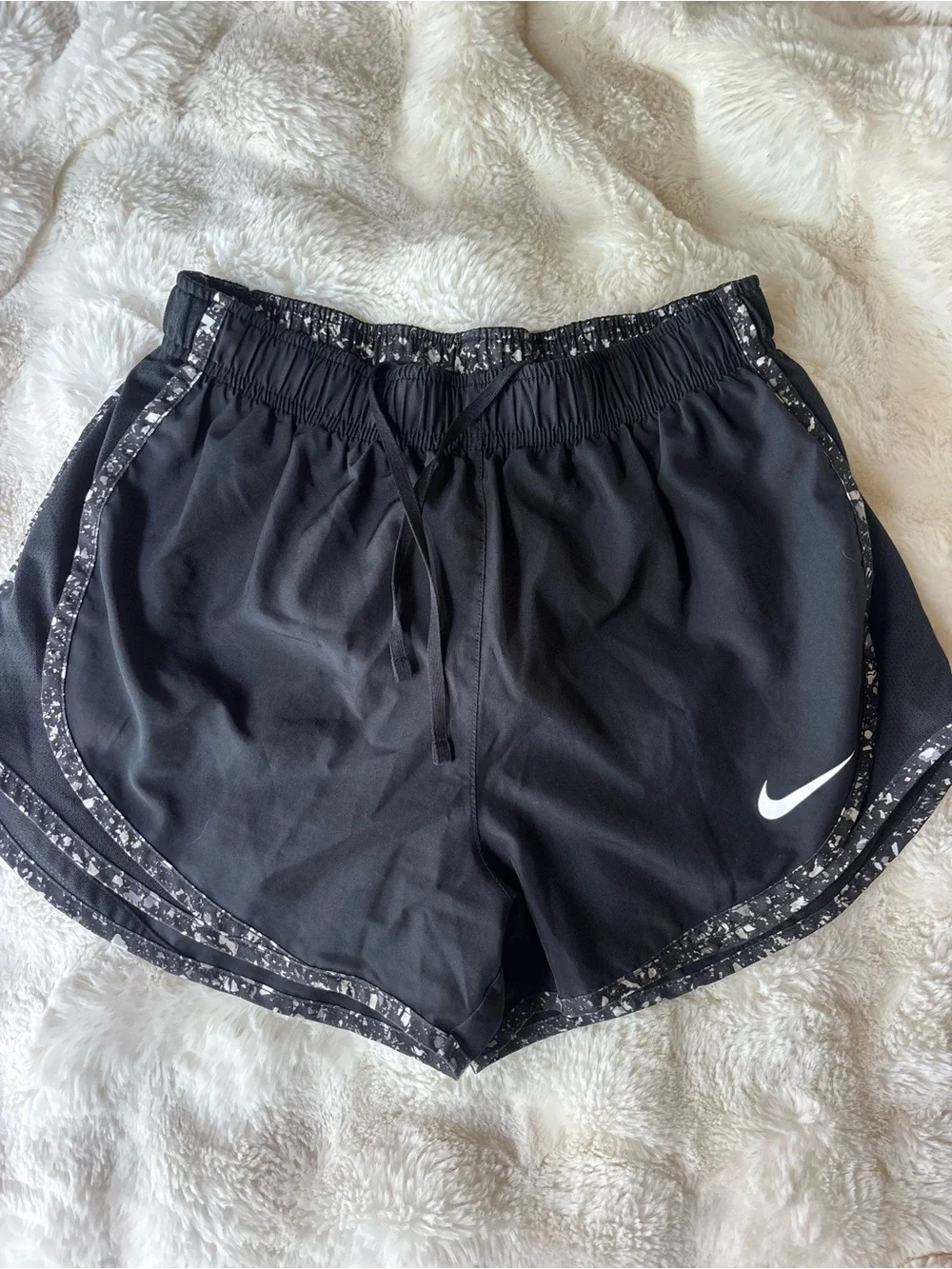 Nike Black Athletic Shorts with White Swoosh and Speckled Trim
